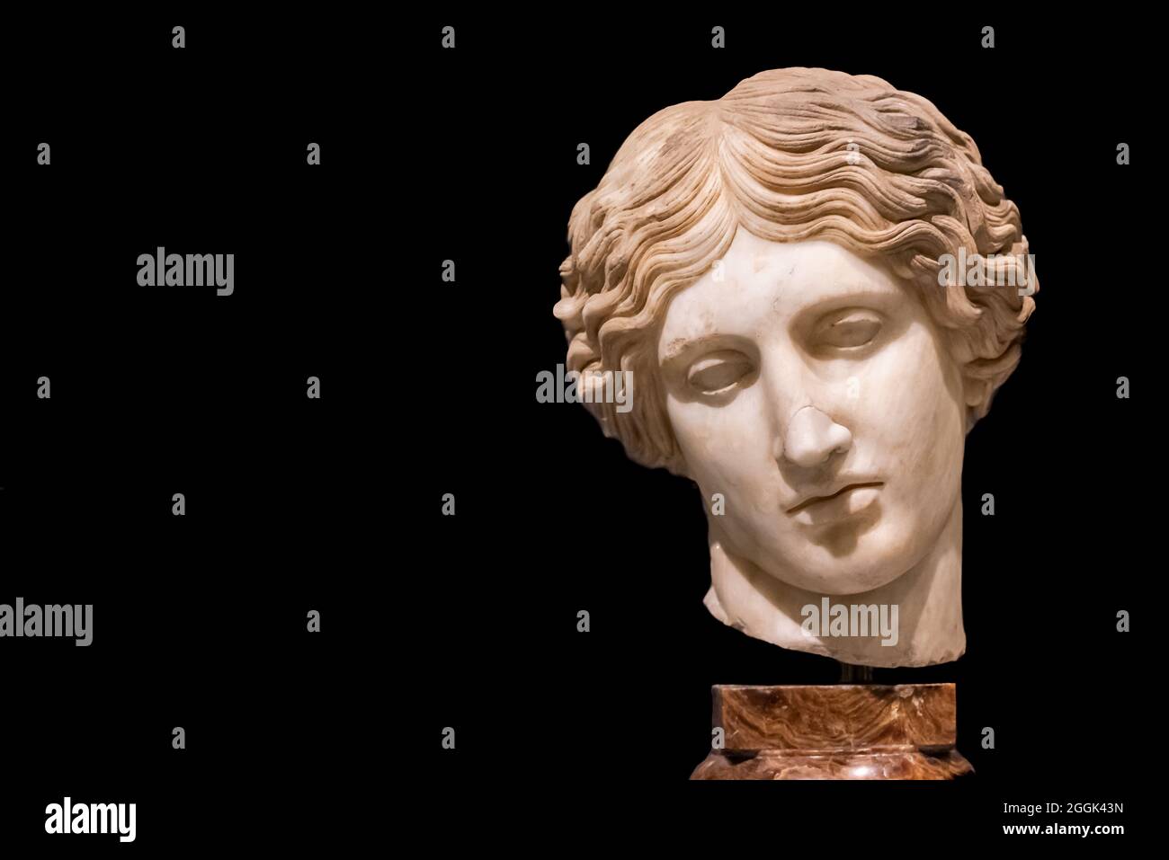 Close-up on broken head of ancient roman statue of sad woman Stock Photo
