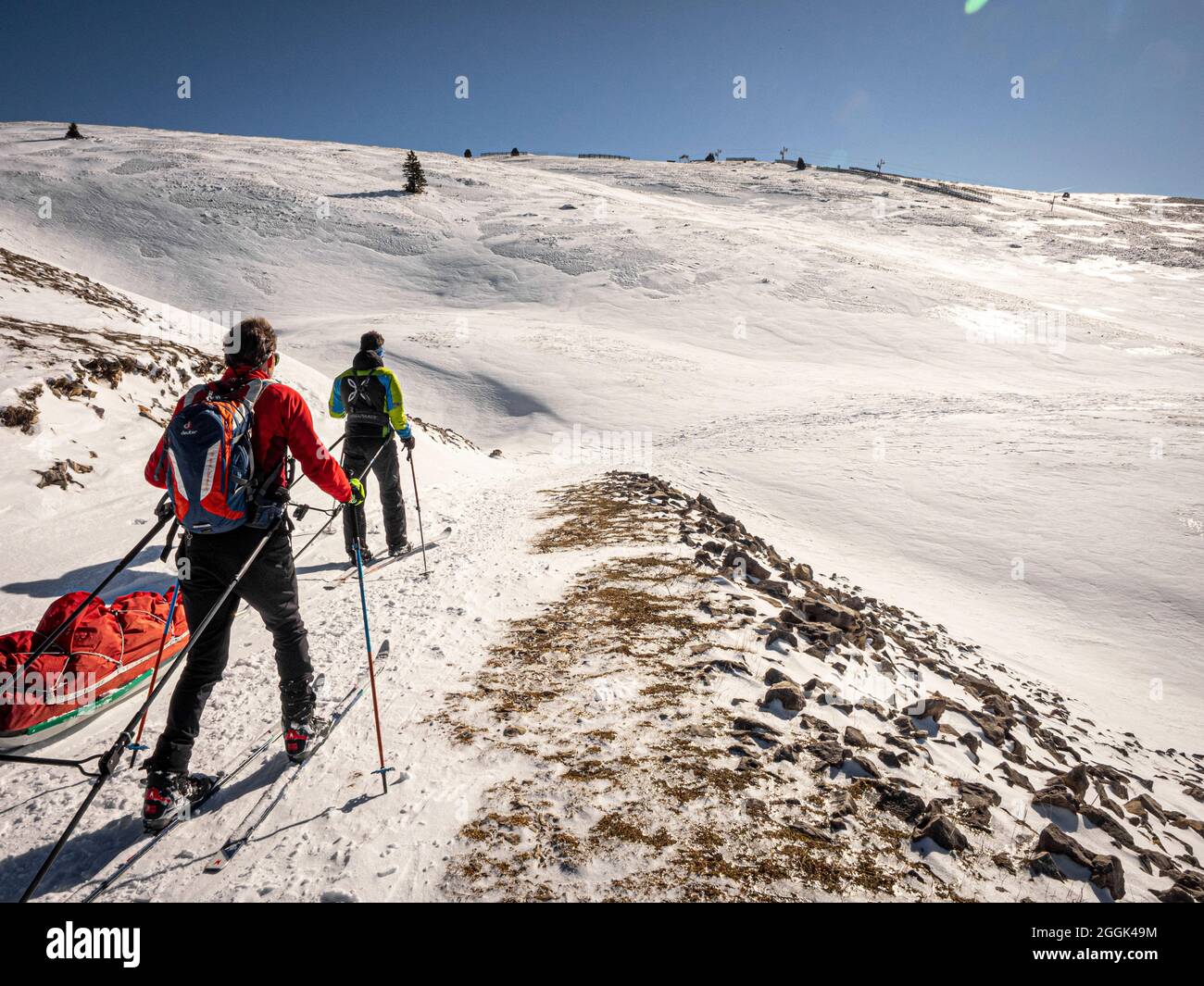 Two skiers on a ski tour with pulka material sledges through the nature  reserve Réserve naturelle des Hauts Plateaux du Vercors, descent at Col du  Rousset Stock Photo - Alamy