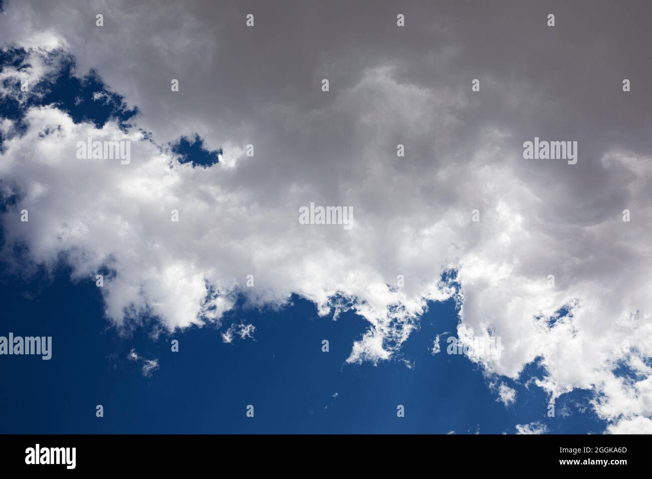 Fluffy white clouds and a deep blue sky. Stock Photo