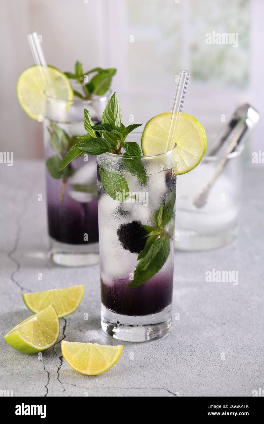 Cold refreshment organic non-alcohol cocktail Blackberry mojito with berry fruit in glass Stock Photo