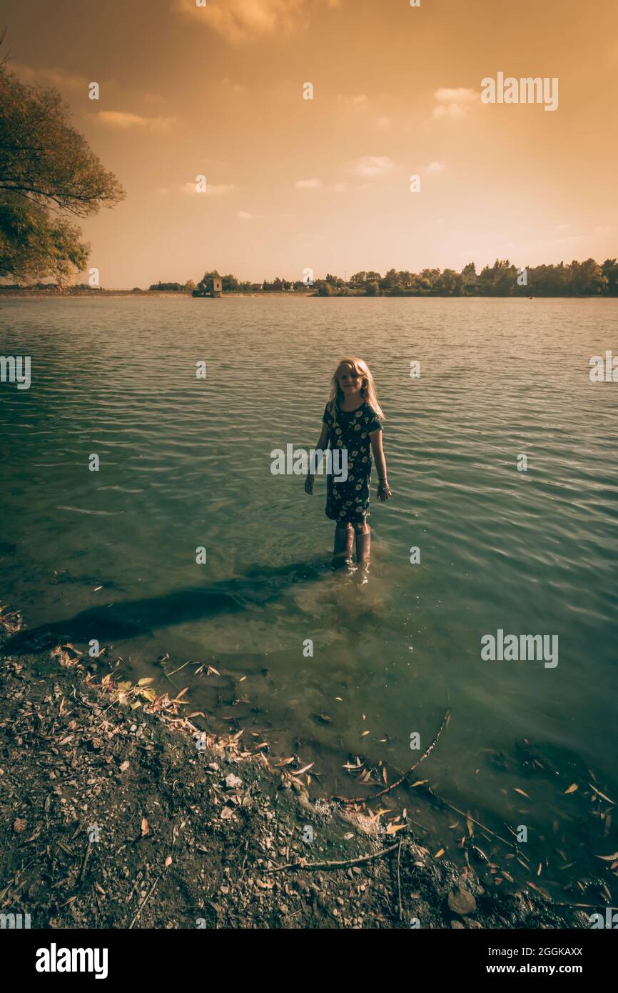 adorable happy girl in wellington boots standing in the river Stock ...
