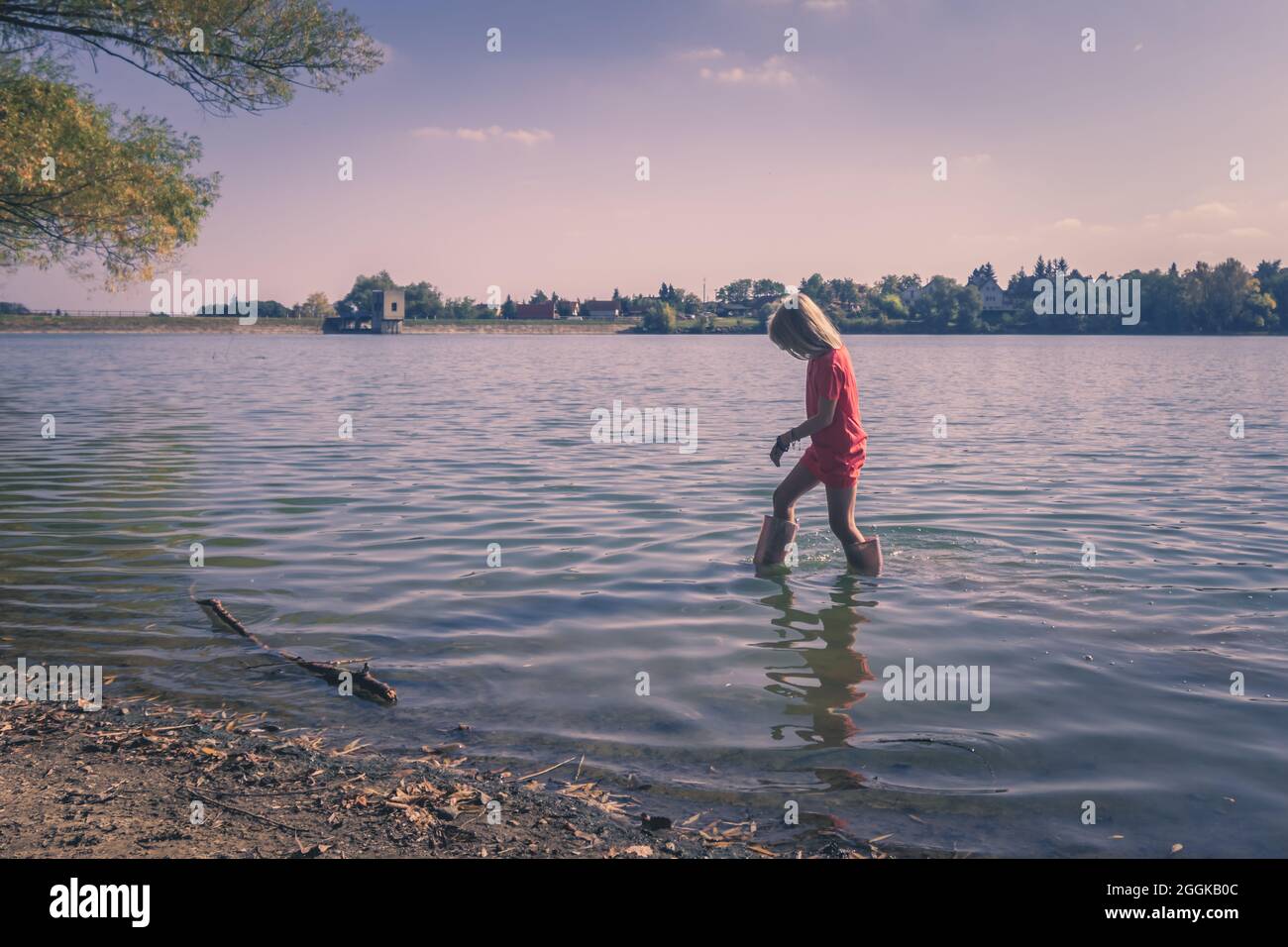 adorable happy girl in wellington boots standing in the river Stock ...