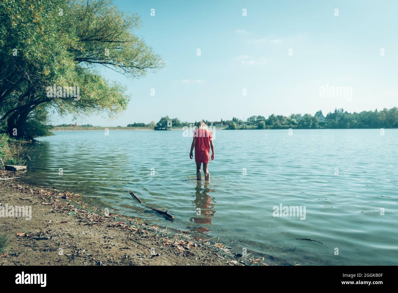 adorable happy girl in wellington boots standing in the river Stock ...