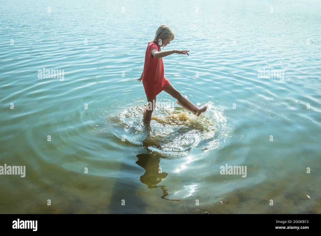 adorable happy girl in wellington boots standing in the river Stock ...