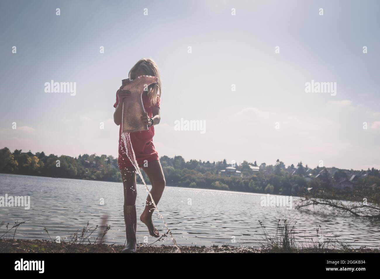 adorable happy girl by the river in the afternoon Stock Photo - Alamy