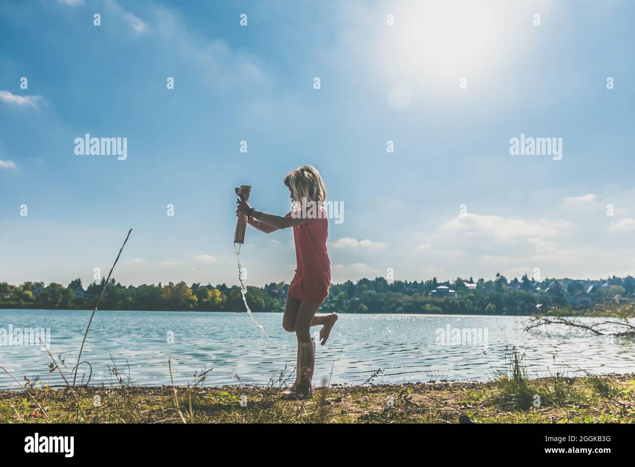 adorable happy girl by the river in the afternoon Stock Photo - Alamy