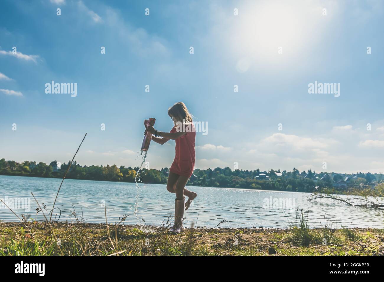 adorable happy girl by the river in the afternoon Stock Photo - Alamy