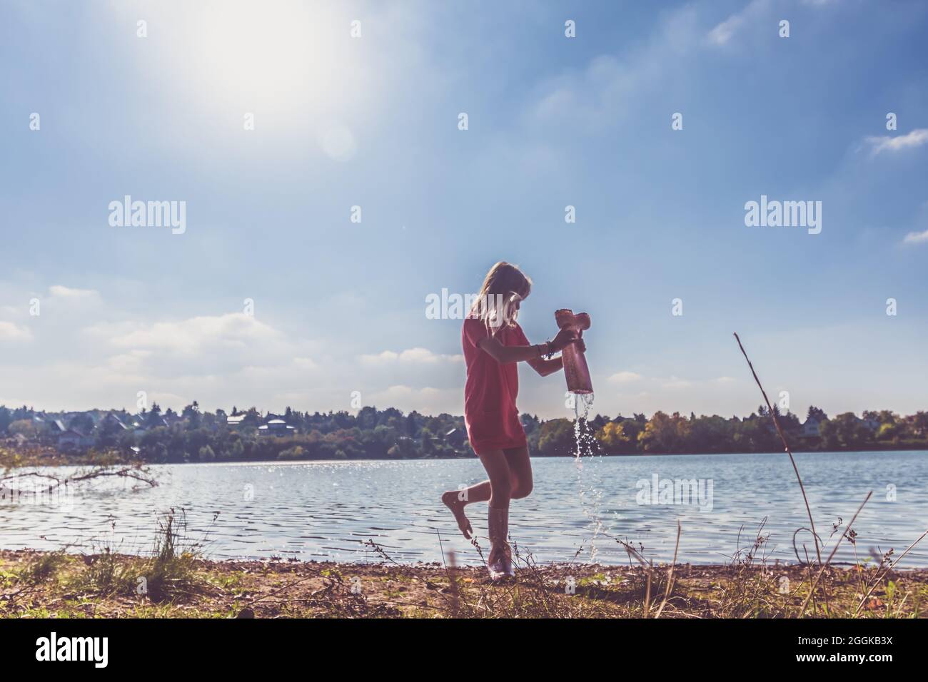 adorable happy girl by the river in the afternoon Stock Photo - Alamy