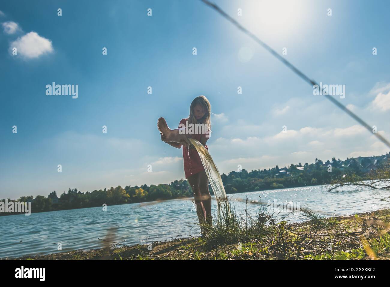 adorable happy girl by the river in the afternoon Stock Photo - Alamy