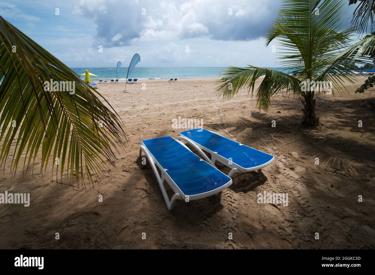 Empty Beach lounges on the Isla Verde Beach in San Juan Puerto Rico, 27 June 2021.  Even though Puerto Rico requires visitors be COVID-19 vaccinated or show a recent negative PCR or antigen test and requires masks or face coverings be worn in indoor spaces.  On 31 August 2021 the Centers for Disease Control and Prevention added Puerto Rico to its list of very high COVID-19 risk destinations and the U.S. State Department issued a “Do Not Travel” advisory for the U.S. territory. Stock Photo