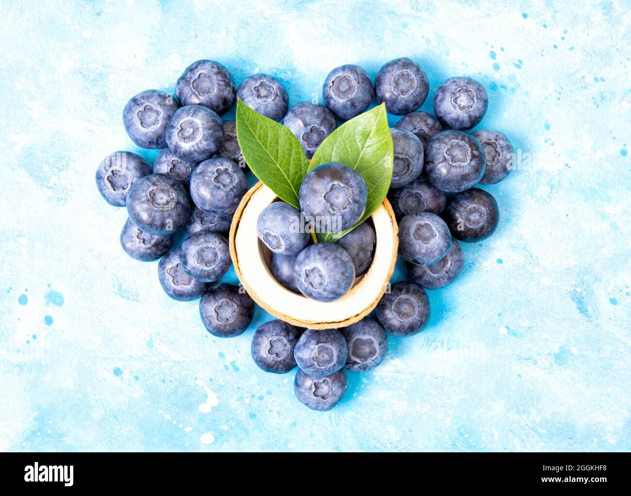 Heart symbol made of fresh blueberries a light blue background. Immunity boosting concept. Stock Photo
