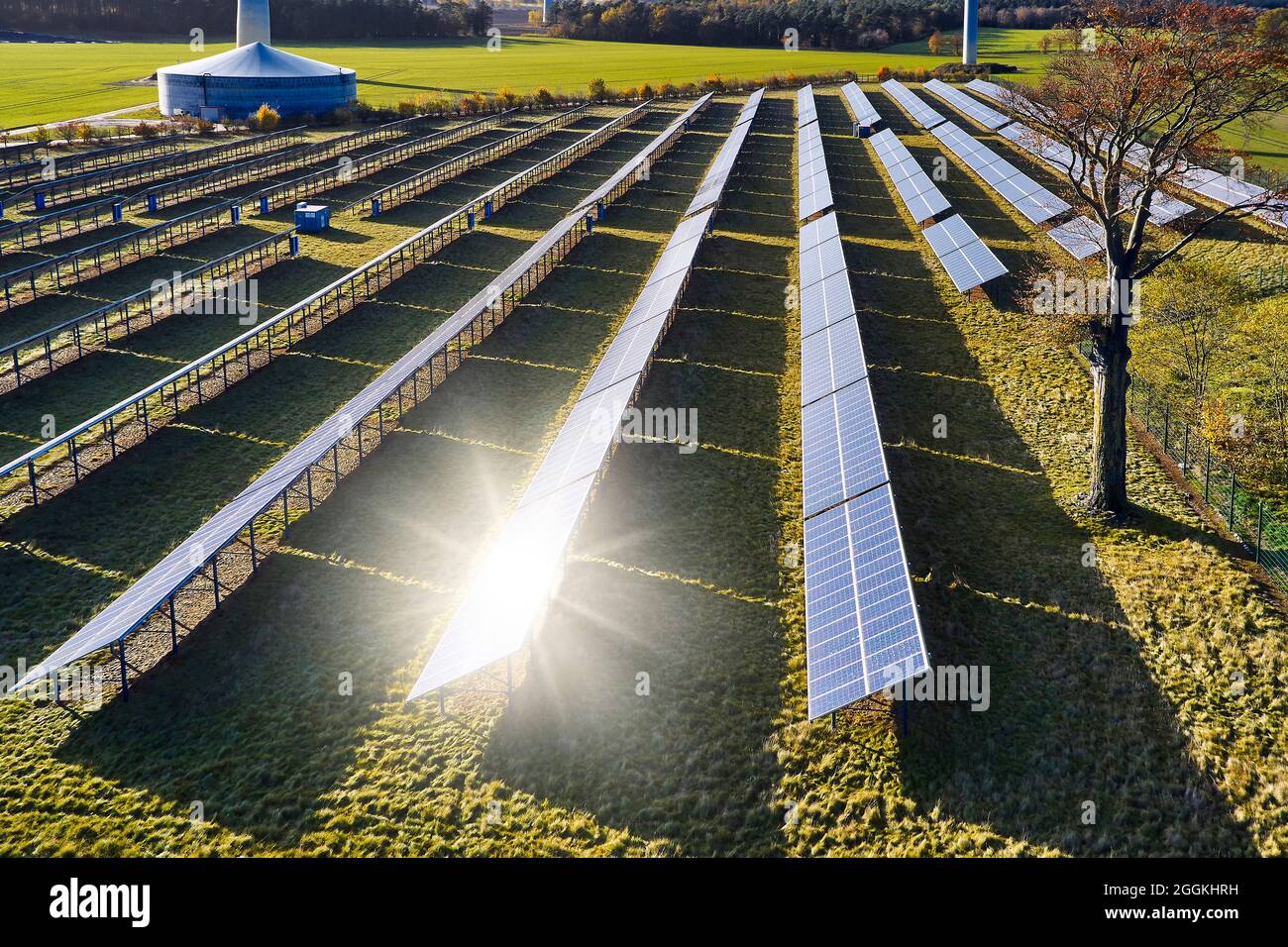 Energy industry, sustainability, wind energy and solar energy, solar field and wind park, solar reflection on solar panel Stock Photo