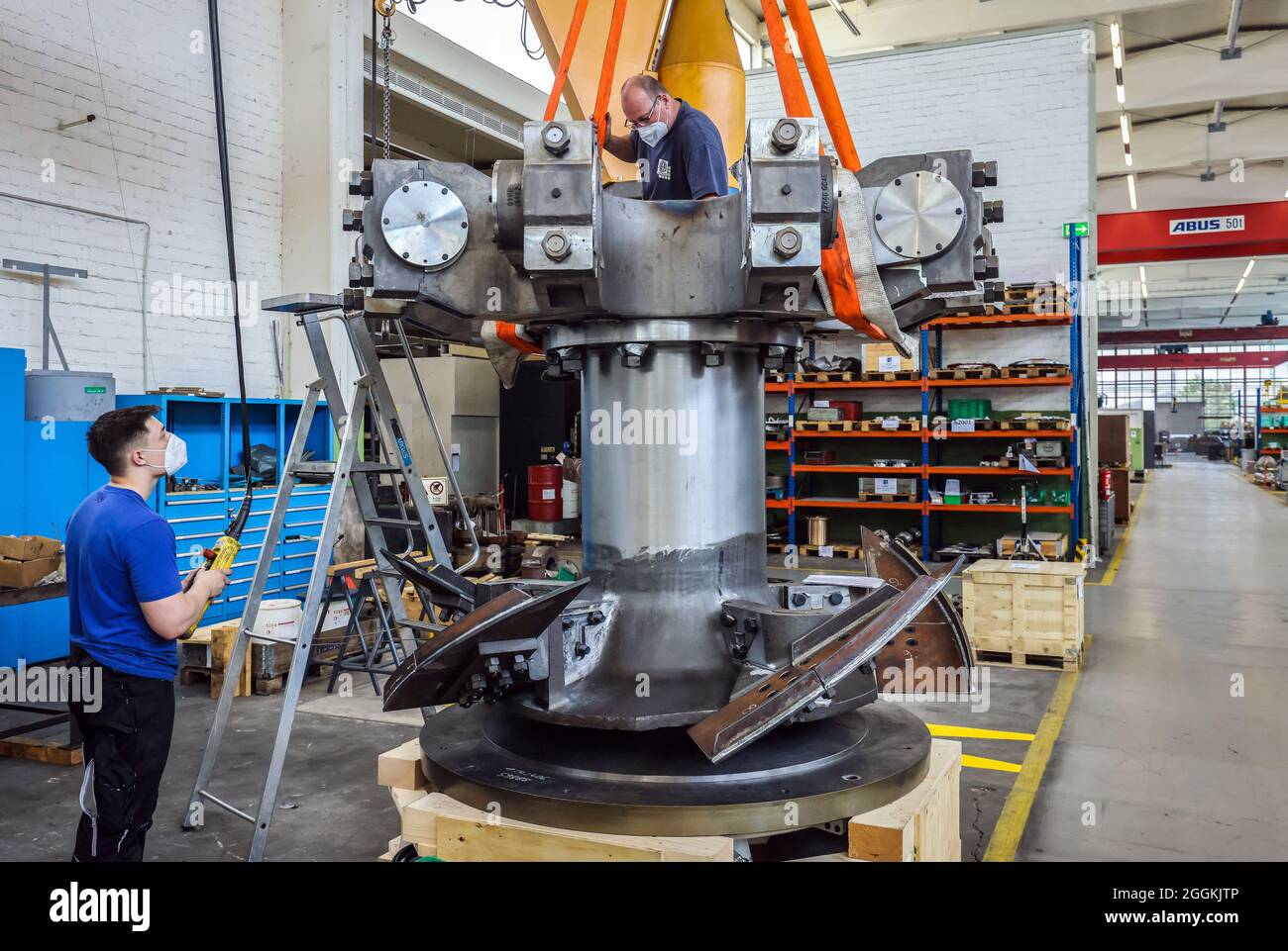 Uebach-Palenberg, North Rhine-Westphalia, Germany - NEA machine works, here employees are building a pendulum mill for a customer in the dye industry in China. NEA also builds compressor systems for compressing process gases, especially H2 and H2 mixed gases. The company NEA Neumann & Esser is planning to set up a PEM electrolysis production facility with the MAPEVA project. The production of green hydrogen by PEM electrolysis of water is suitable for storing, transporting and using the generated renewable energy. Stock Photo