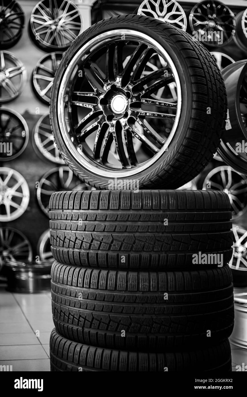 A pyramid of rubber tires and alloy wheels. Purchase and sale of new
