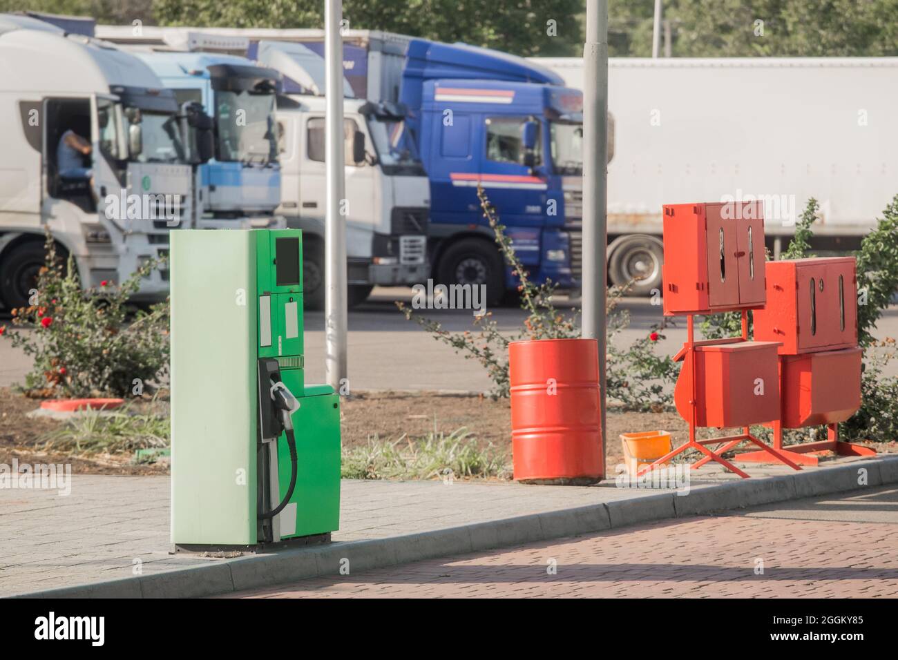 Gas station at the refueling next to the fire box with tools and equipment against the background of truck car. Stock Photo