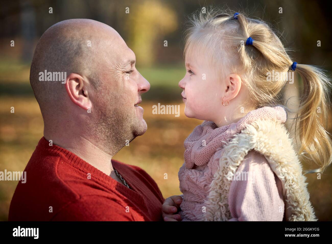Scene of quiet family happiness filiation and love. Happy caucasian father and his little daughter face to face closely looking into each others eyes Stock Photo