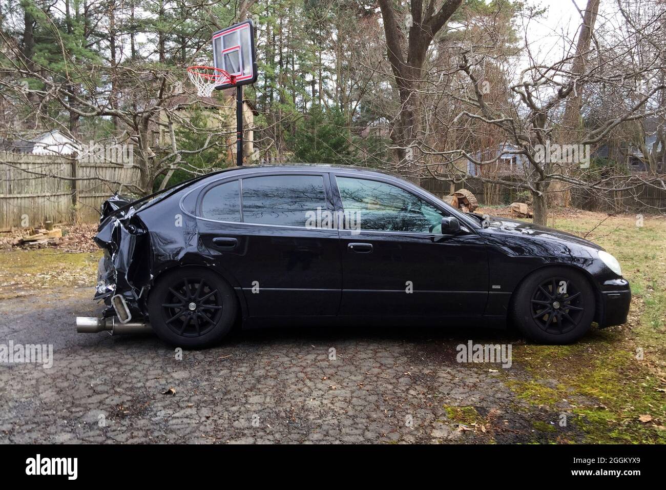 Black car with rear end damage from a car accident (rear end collision) - USA Stock Photo