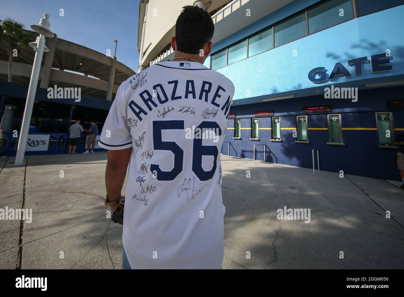 St. Petersburg, FL. USA; A Tampa Bay Rays fan proudly wears his left  fielder Randy Arozarena (56) jersey with many players autographs during a  major league baseball game against the Boston Red