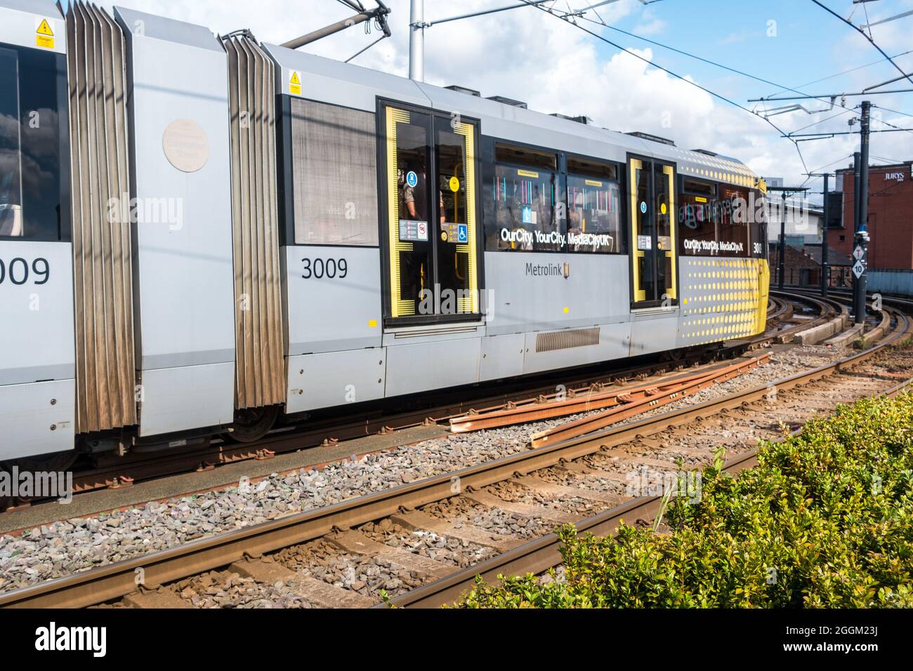 Metrolink Manchester yellow tram as part of Transport for Greater Manchester  connecting the city and urban areas around Stock Photo - Alamy