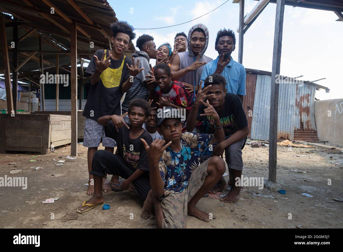 Sorong, Indonesia - Oct 3, 2019: A group of lively young lads goof around and make weird faces in a neighborhood of Sorong, West Papua Stock Photo