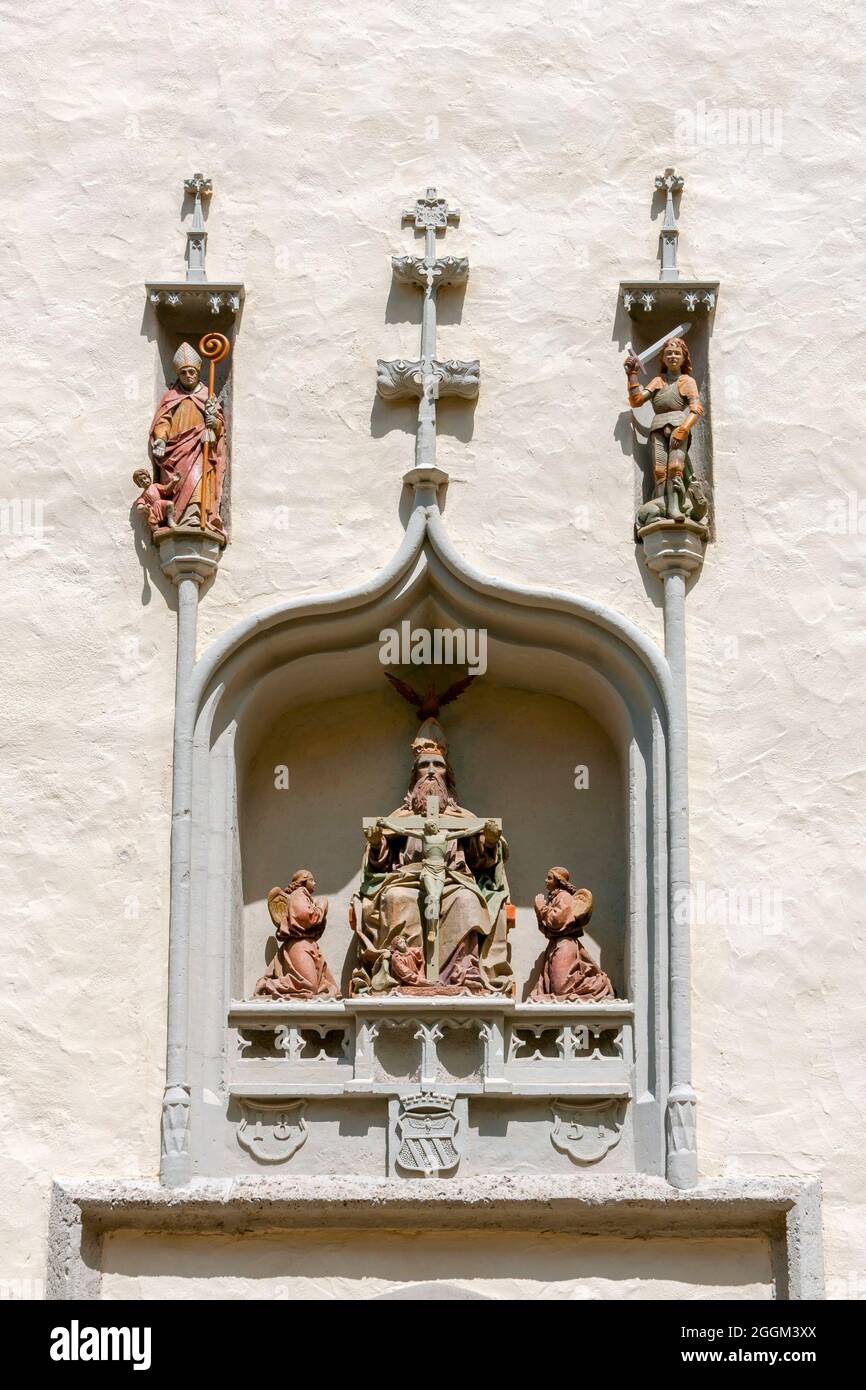 Germany, Baden-Wuerttemberg, Ehingen / Danube, mercy seat at the hospital chapel. The representation of the Trinity - God the Father figure with the cross in his hands and the Holy Spirit as a dove, next to it angel figures and above it Saint George and Augustine with a begging child. Stock Photo