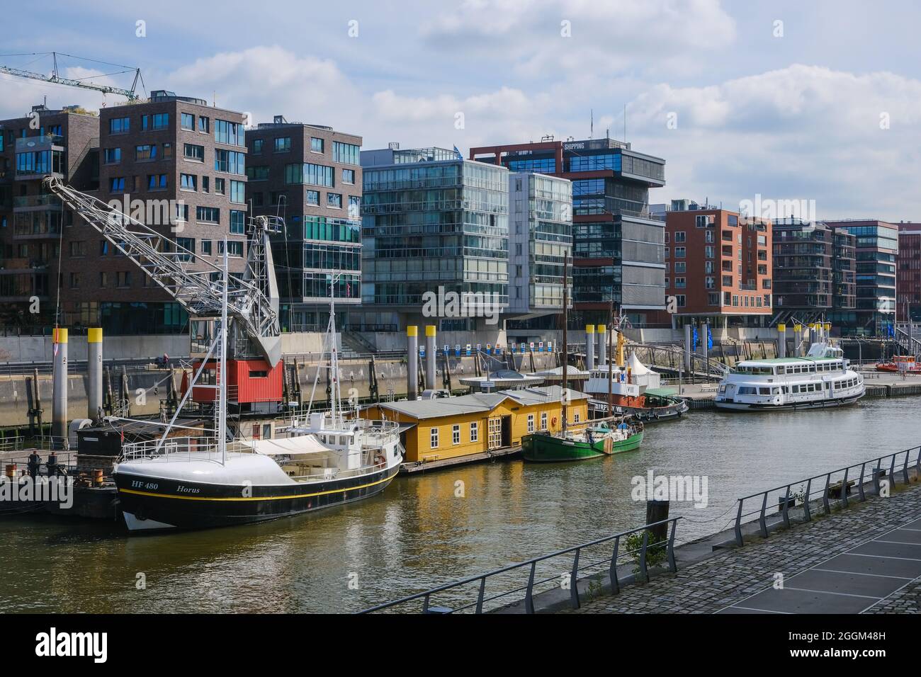 Hamburg, Germany - Hafencity, modern residential buildings and office buildings in the Sandtorhafen, in the traditional ship port with old port crane. Stock Photo