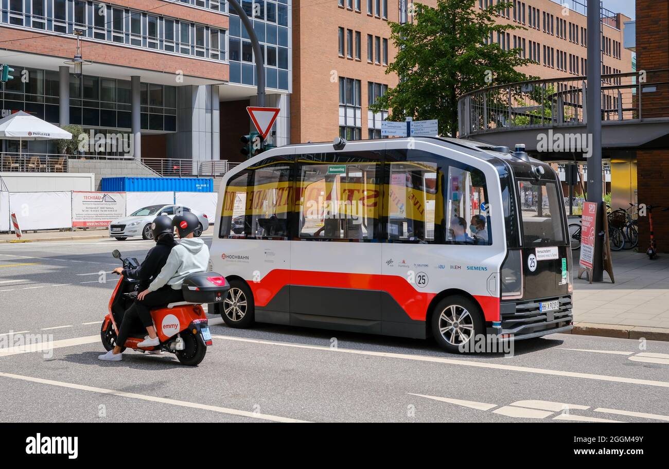 Hamburg, Germany - Autonomous elevated railway electric bus and an Emmy electric scooter in Hamburg's Hafencity. Stock Photo