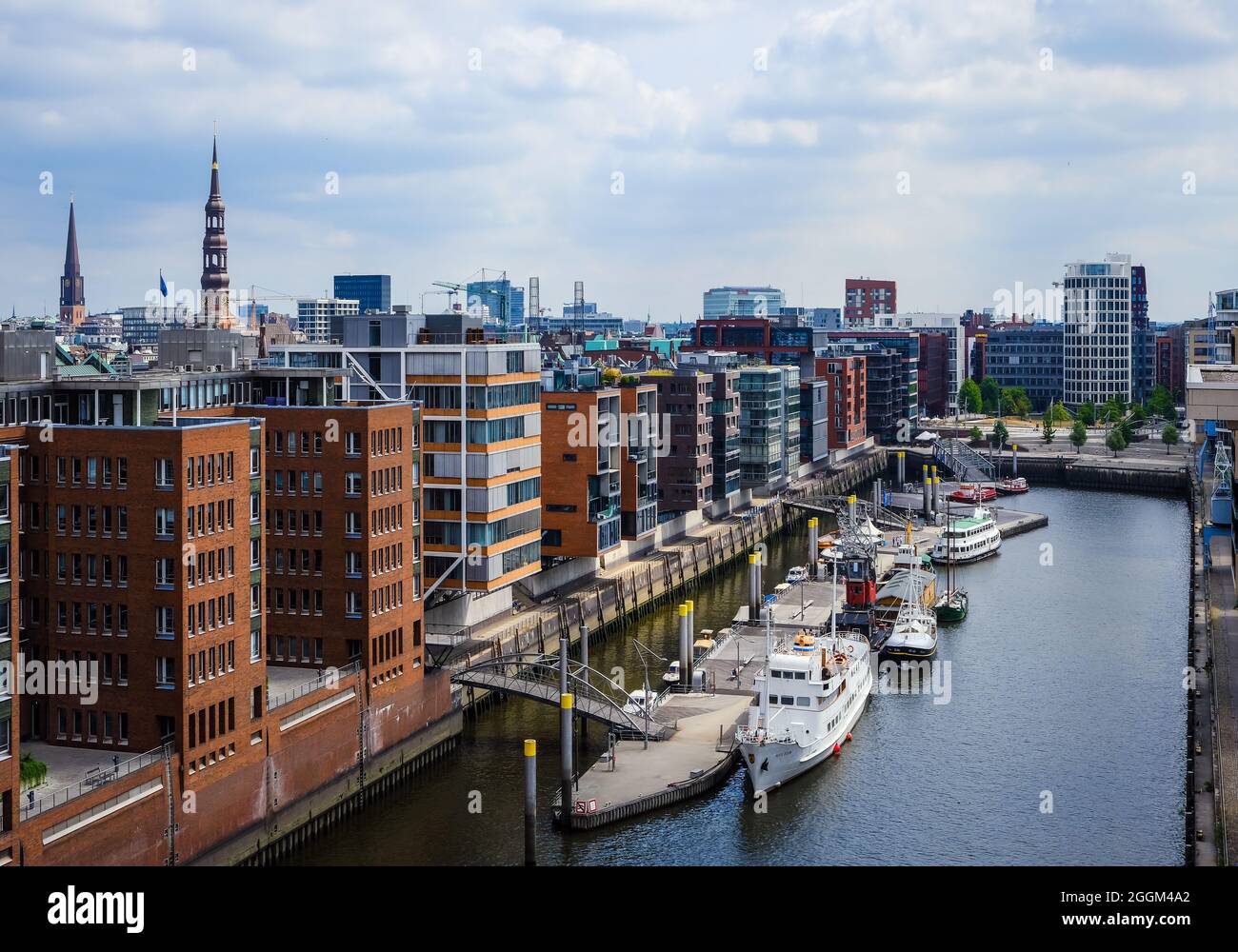 Hamburg, Germany - Hafencity, modern residential buildings in the Sandtorhafen, in the traditional ship port with old port crane. Stock Photo