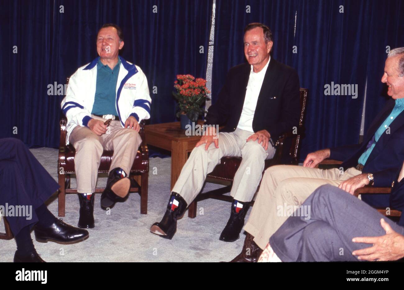 Houston Texas USA, July1990: U.S. President George H.W. Bush shows off his Texas-themed cowboy boots during an informal event with other world leaders during the Houston Economic Summit of Industrialized Nations. ©Bob Daemmrich Stock Photo