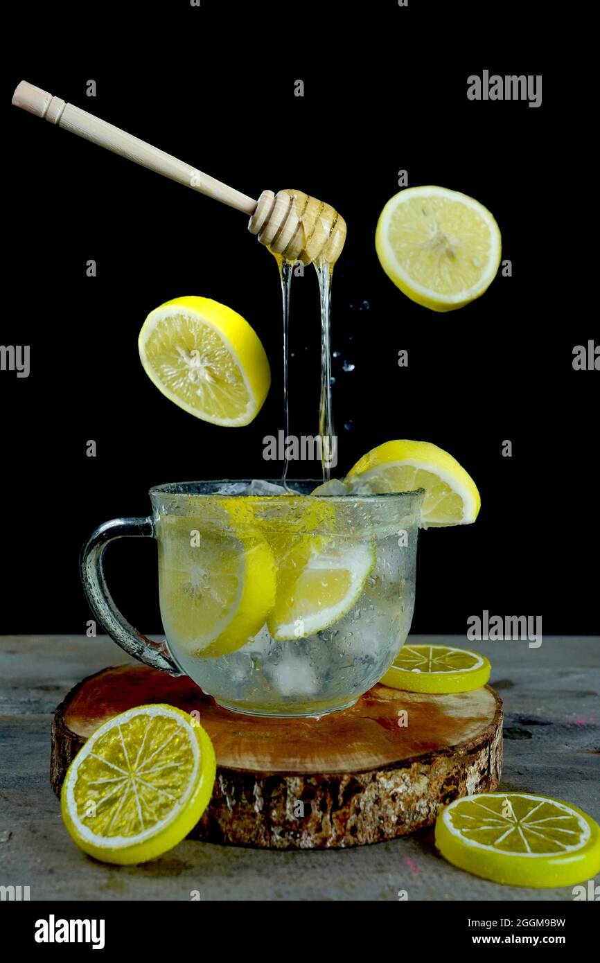 Vertical shot of floating honey dipper on an iced lemonade perfect