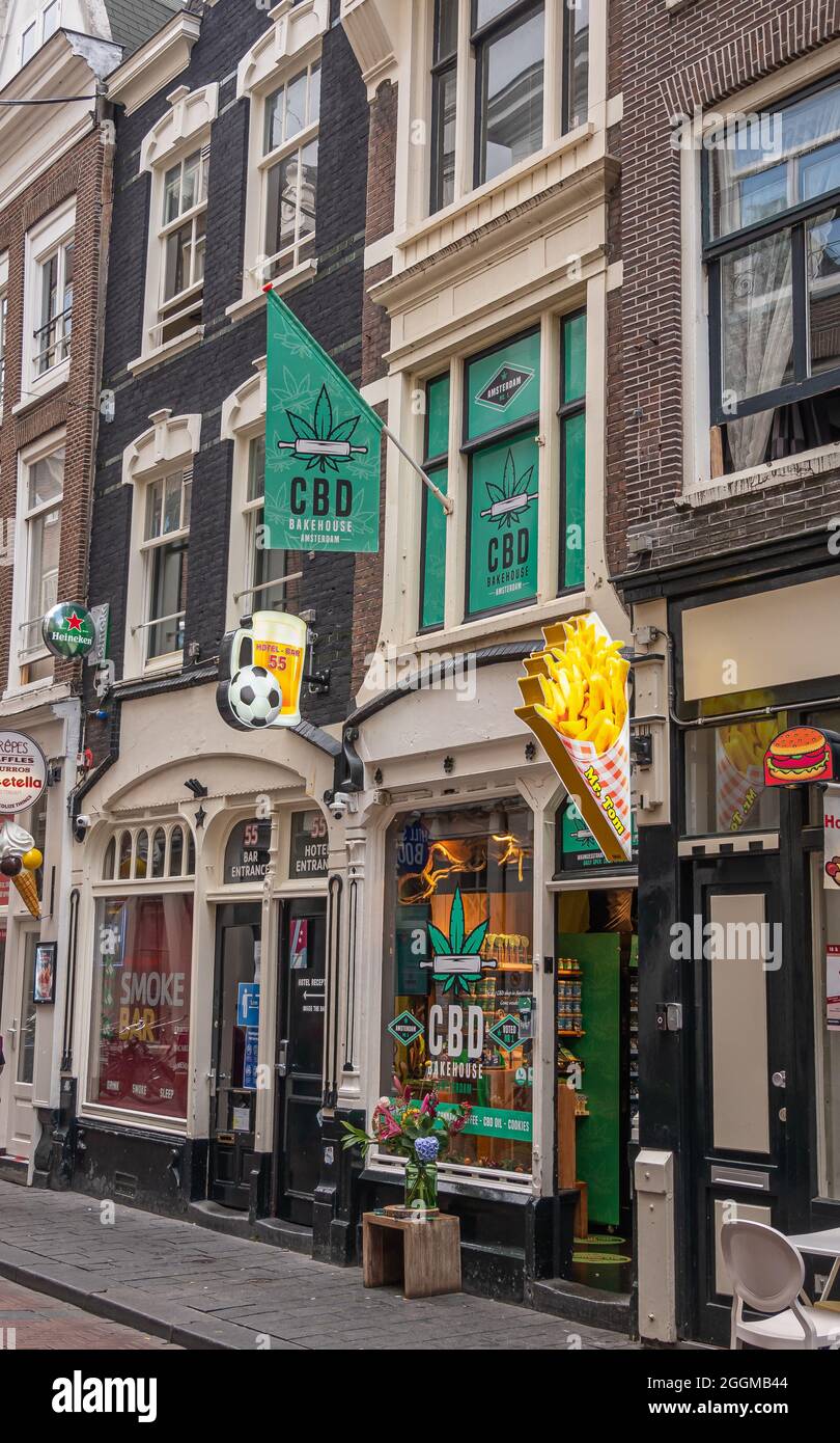 Amsterdam, Netherlands - August 14, 2021: Warmoesstraat. CBD cannabis Bakehouse adjacent to Smoke Bar and hotel. One sells bakery products with CBD, t Stock Photo