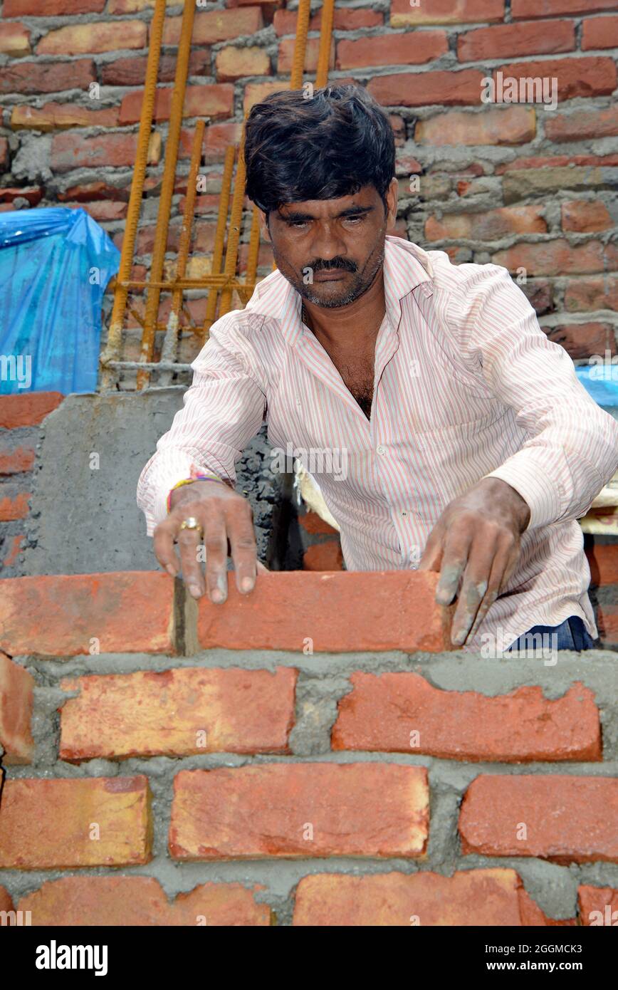 Manual Workers doing laborious job at a rural construction site in New