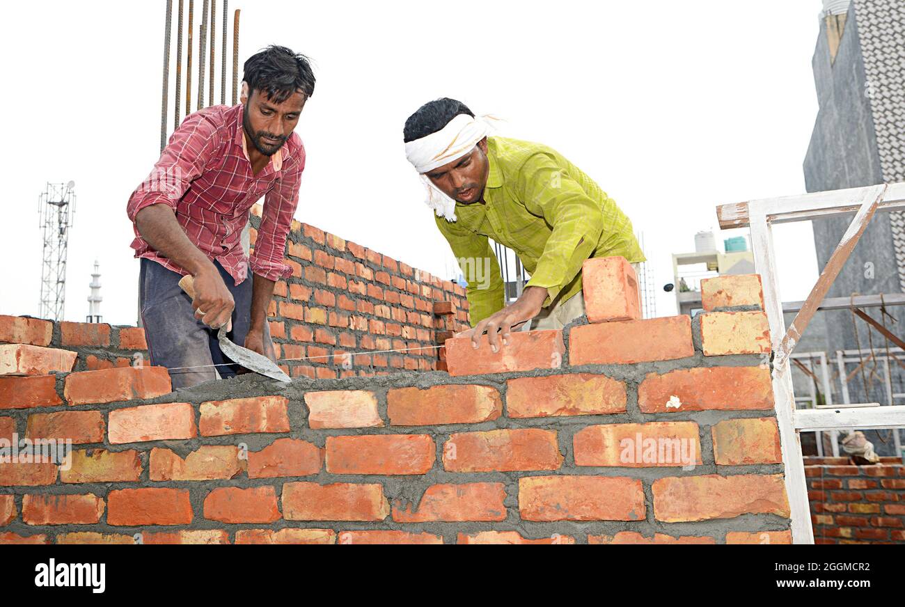 Manual Workers doing laborious job at a rural construction site in New