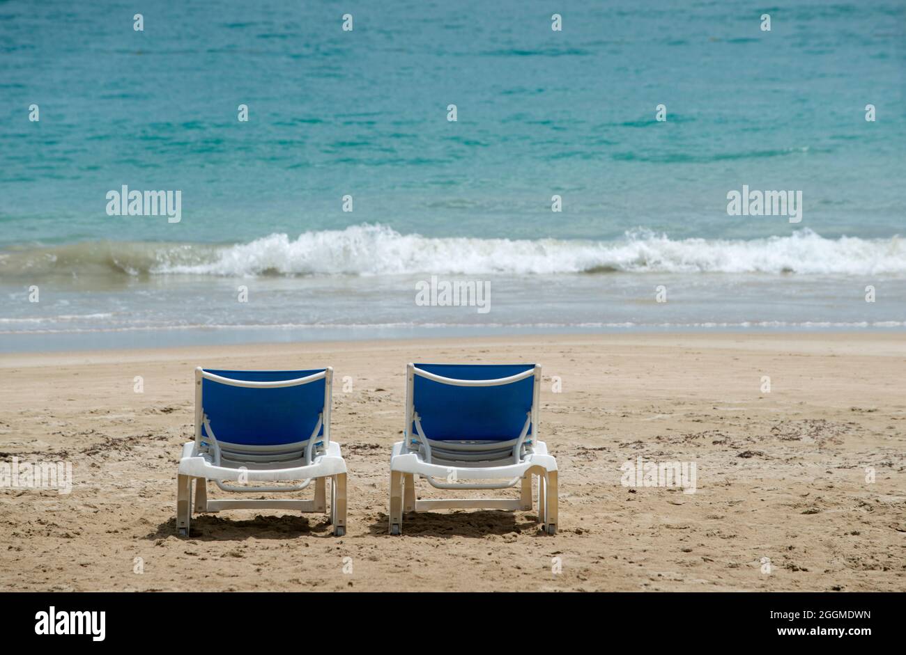 Empty Beach lounges on the Isla Verde Beach in San Juan Puerto Rico, 27 June 2021.  Even though Puerto Rico requires visitors be COVID-19 vaccinated or show a recent negative PCR or antigen test and requires masks or face coverings be worn in indoor spaces.  On 31 August 2021 the Centers for Disease Control and Prevention added Puerto Rico to its list of very high COVID-19 risk destinations and the U.S. State Department issued a “Do Not Travel” advisory for the U.S. territory. Stock Photo