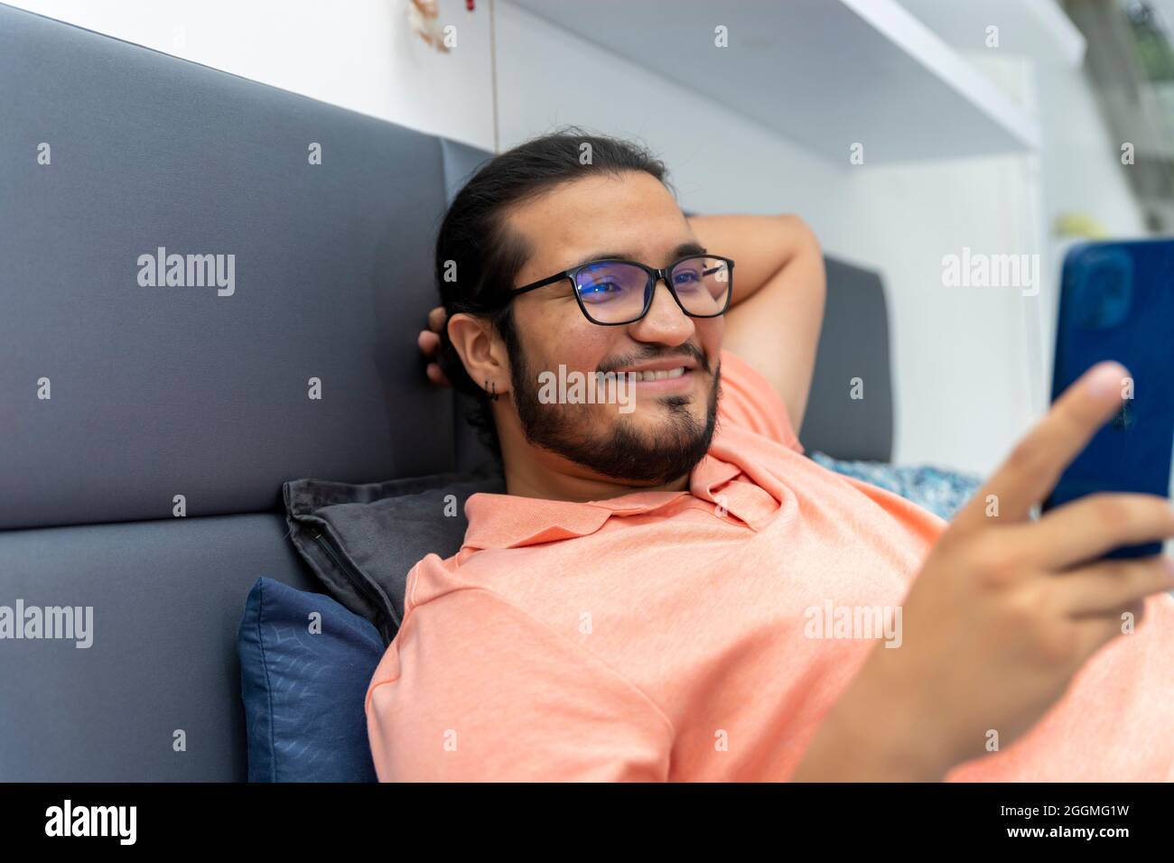 close up of a relaxed latino man in cell phone Stock Photo