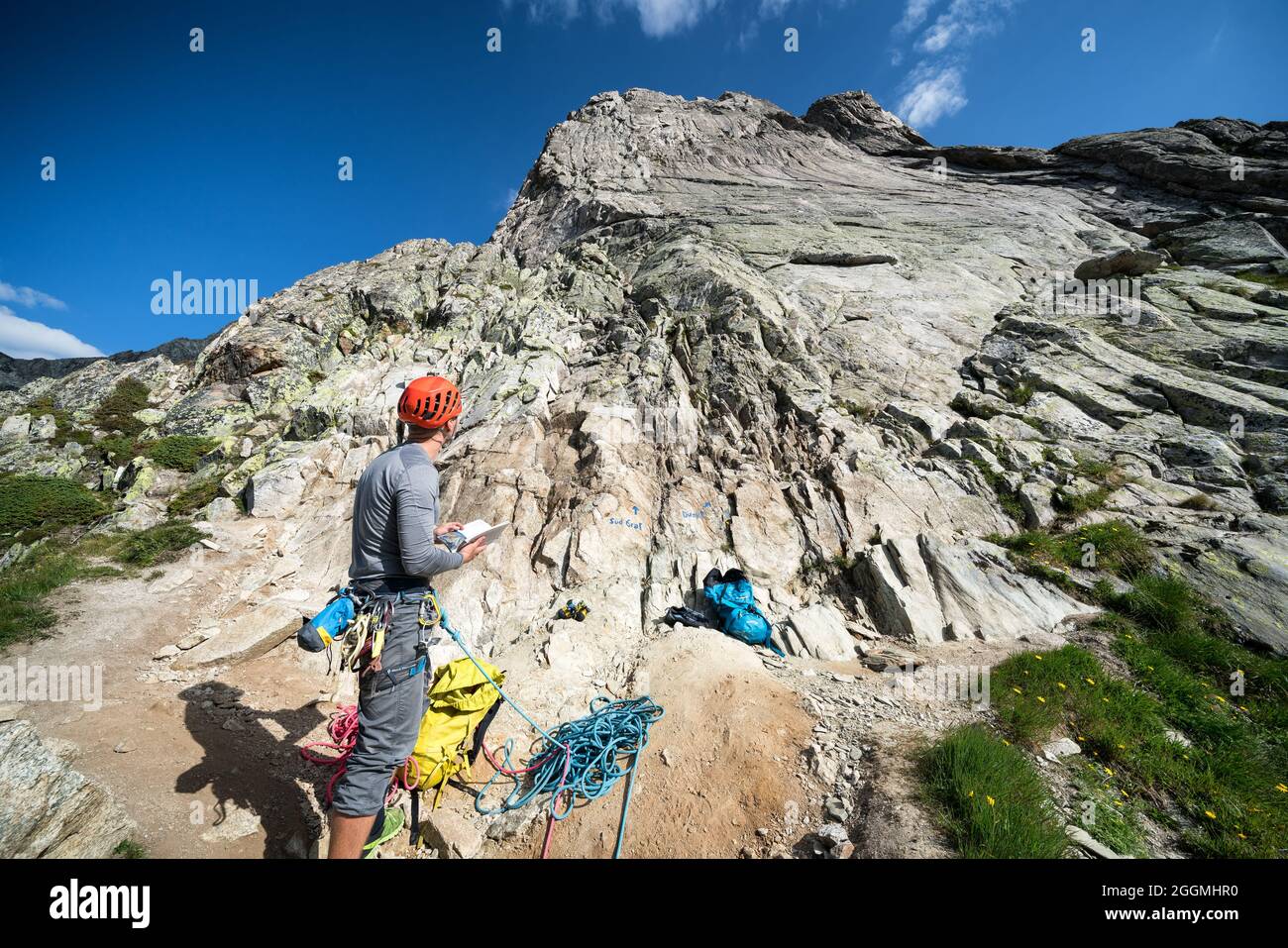 A rock climber getting ready for climbing near Göscheneralp, Switzerland, Alps Stock Photo