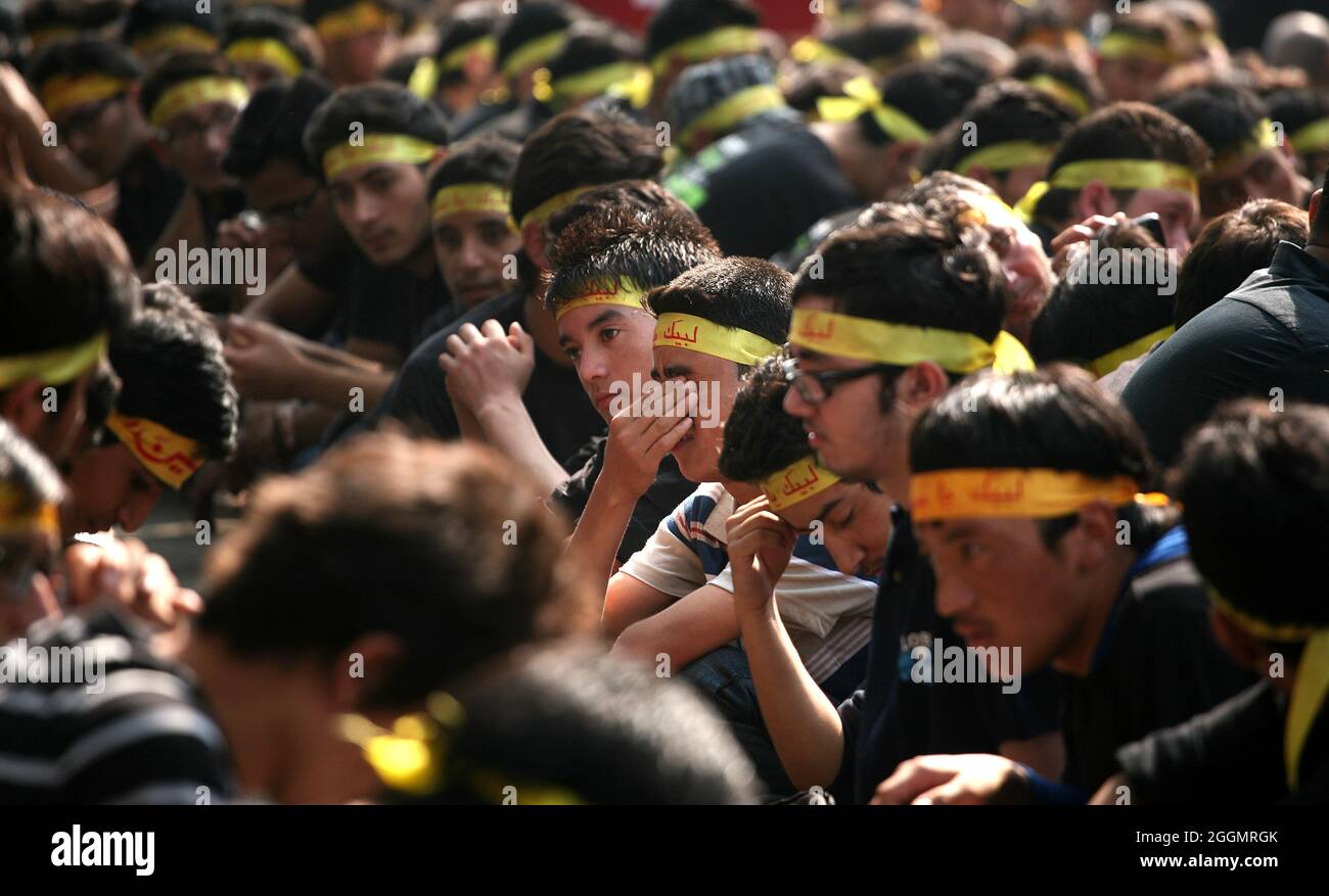 Indian Shiite Mulslims take part in a ritual of self flagellation during the procession to mark Ashura during the month of Muharram In New Delhi Stock Photo