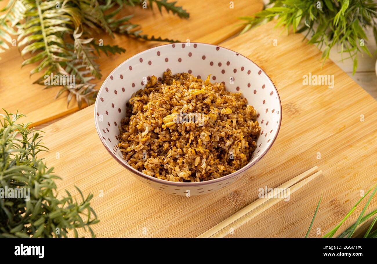 Fried rice in the bowl on the wooden table Stock Photo