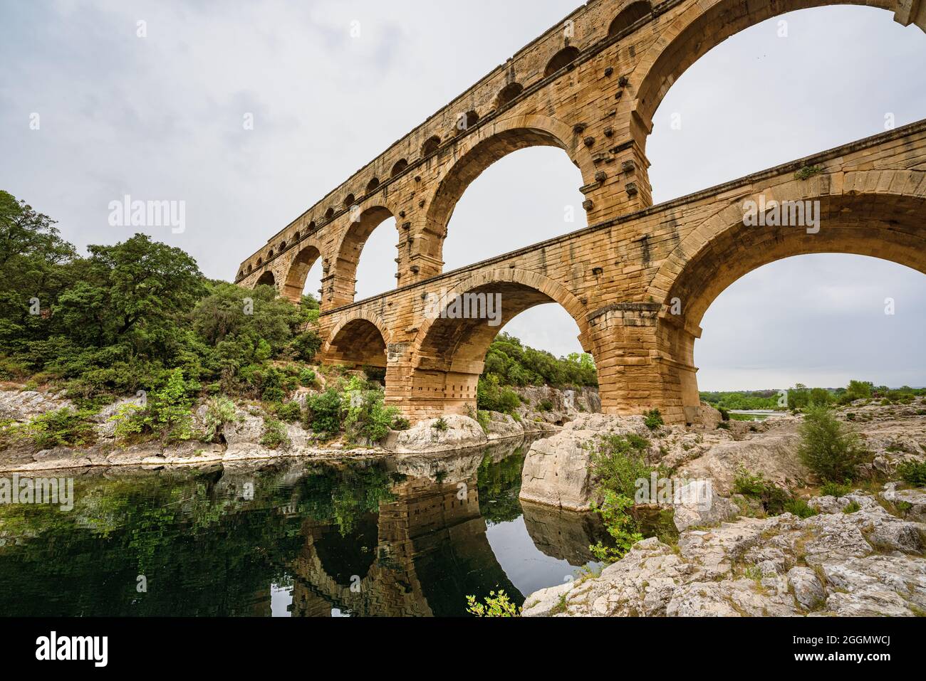 Low angle view of a Roman Empire aqueduct, Pont du Gard in France. Ancient civilisation engineering for water supply. Stock Photo