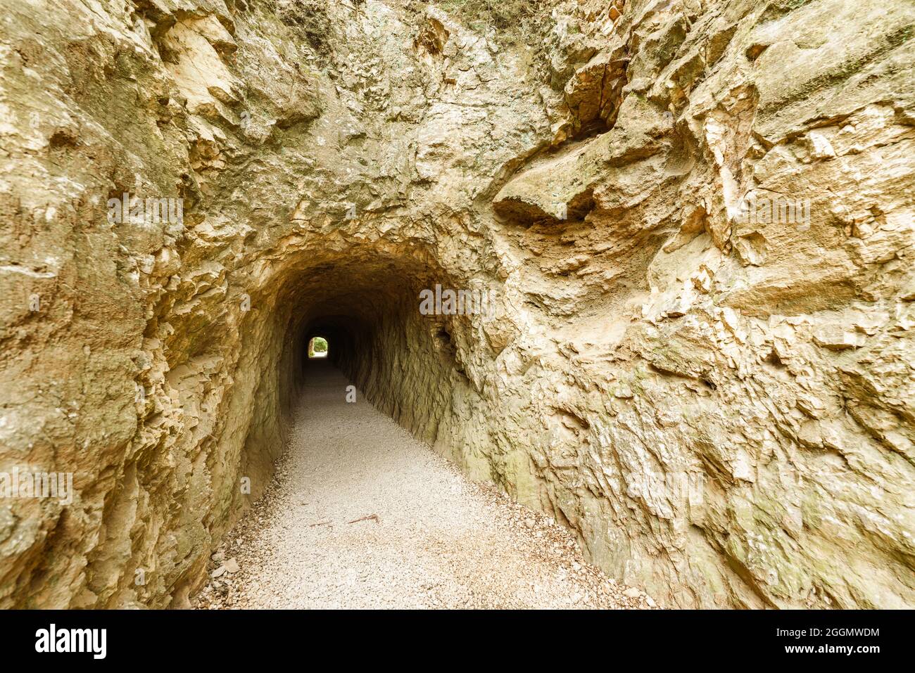 Tunnel of a Roman aqueduct carved into the rock of a mountain Stock
