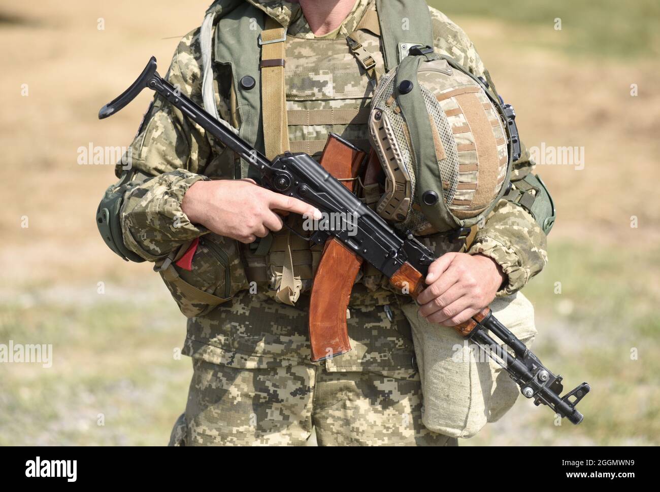 Soldier of Ukraine Ukrainian soldier with assault rifle AK. Stock Photo