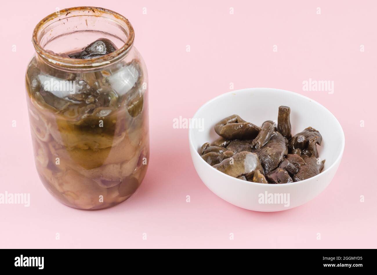 Botulism, food poisoning from canned foods concept. Glass jar and white