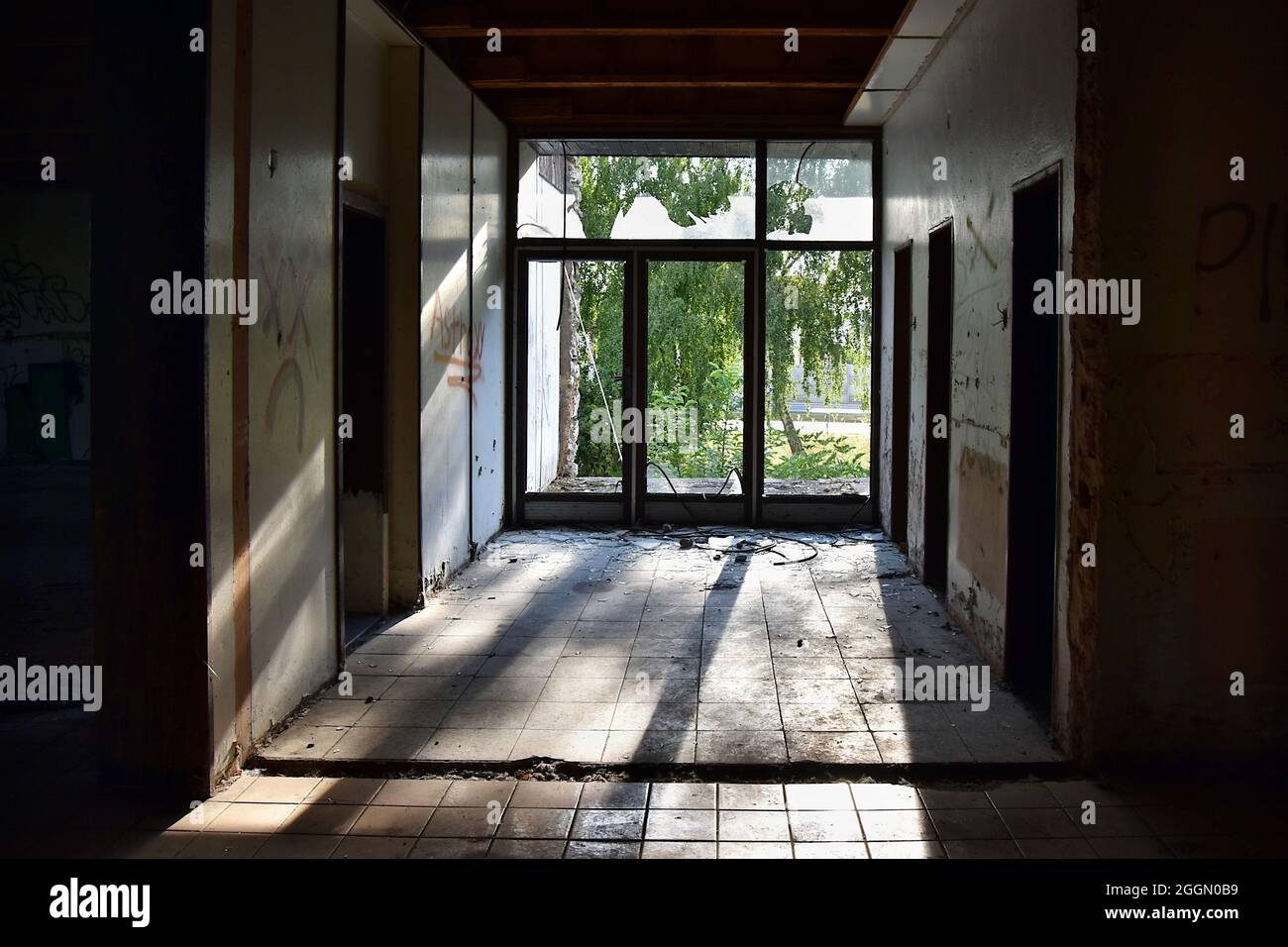 Entrance in derelict building with broken glass Stock Photo - Alamy