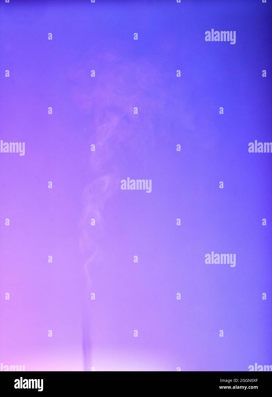 Smoke rising from diffuser with red blue purple neon gradient light Stock Photo