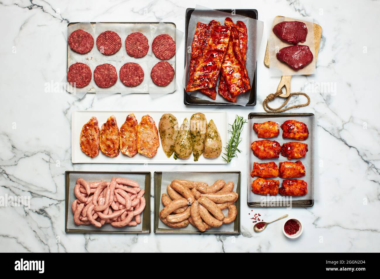 Various cuts of meat on a marble background Stock Photo