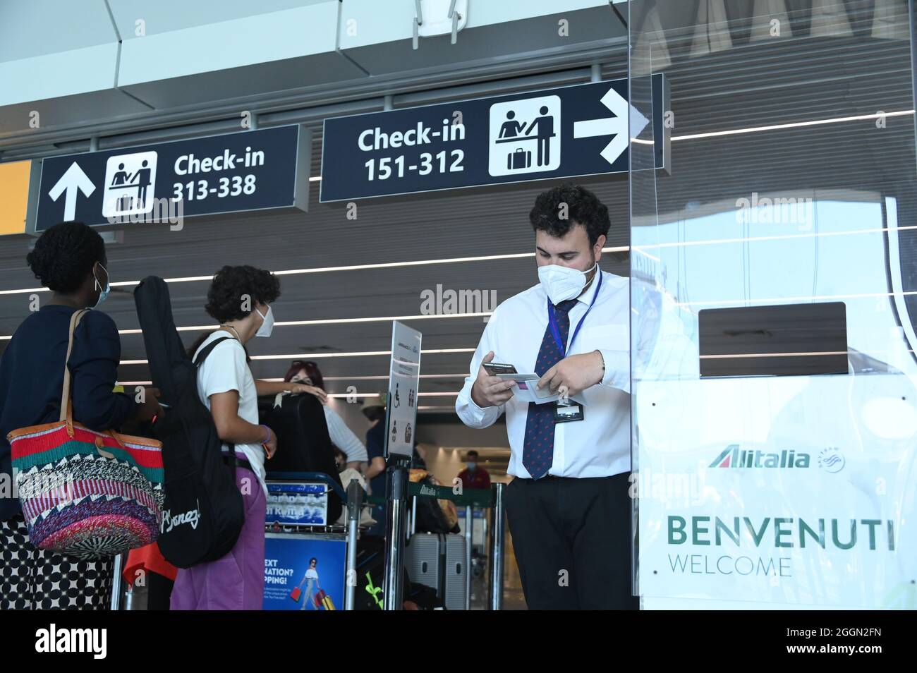 Rome, Italy. 1st Sep, 2021. A staff member checks the COVID-19 green pass of a passenger at Fiumicino airport in Rome, Italy, on Sept. 1, 2021. The COVID-19 green pass on Wednesday became mandatory in Italy for long-haul means of transportation such as airplanes, ships and ferries, and trains. The green pass is a certificate issued by Italian health authorities that shows people have been vaccinated or have tested negative or have recovered from COVID-19. Credit: Alberto Lingria/Xinhua/Alamy Live News Stock Photo