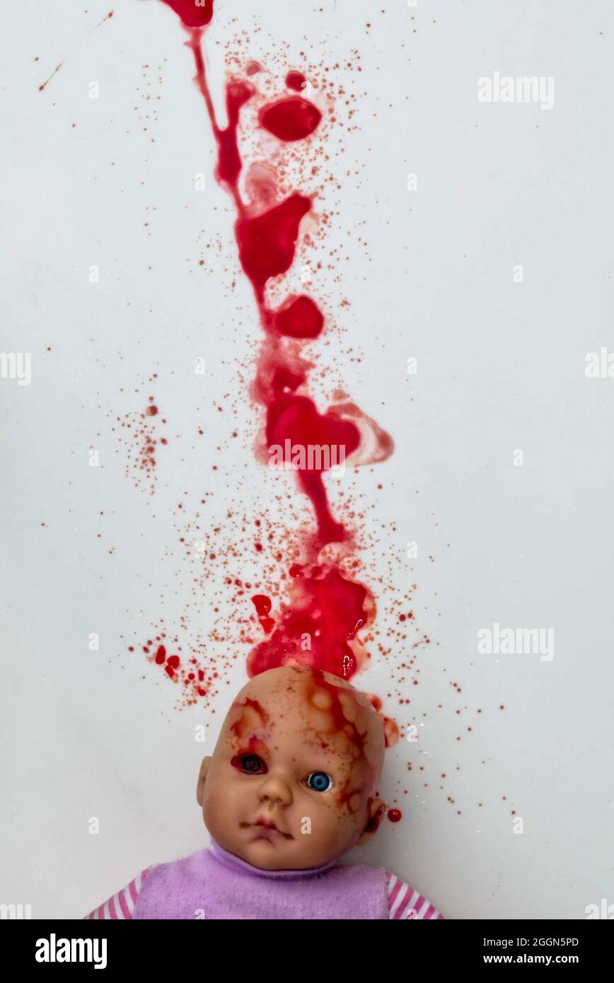 dolls head with trail of blood and splatter. horror! (book cover) Stock Photo