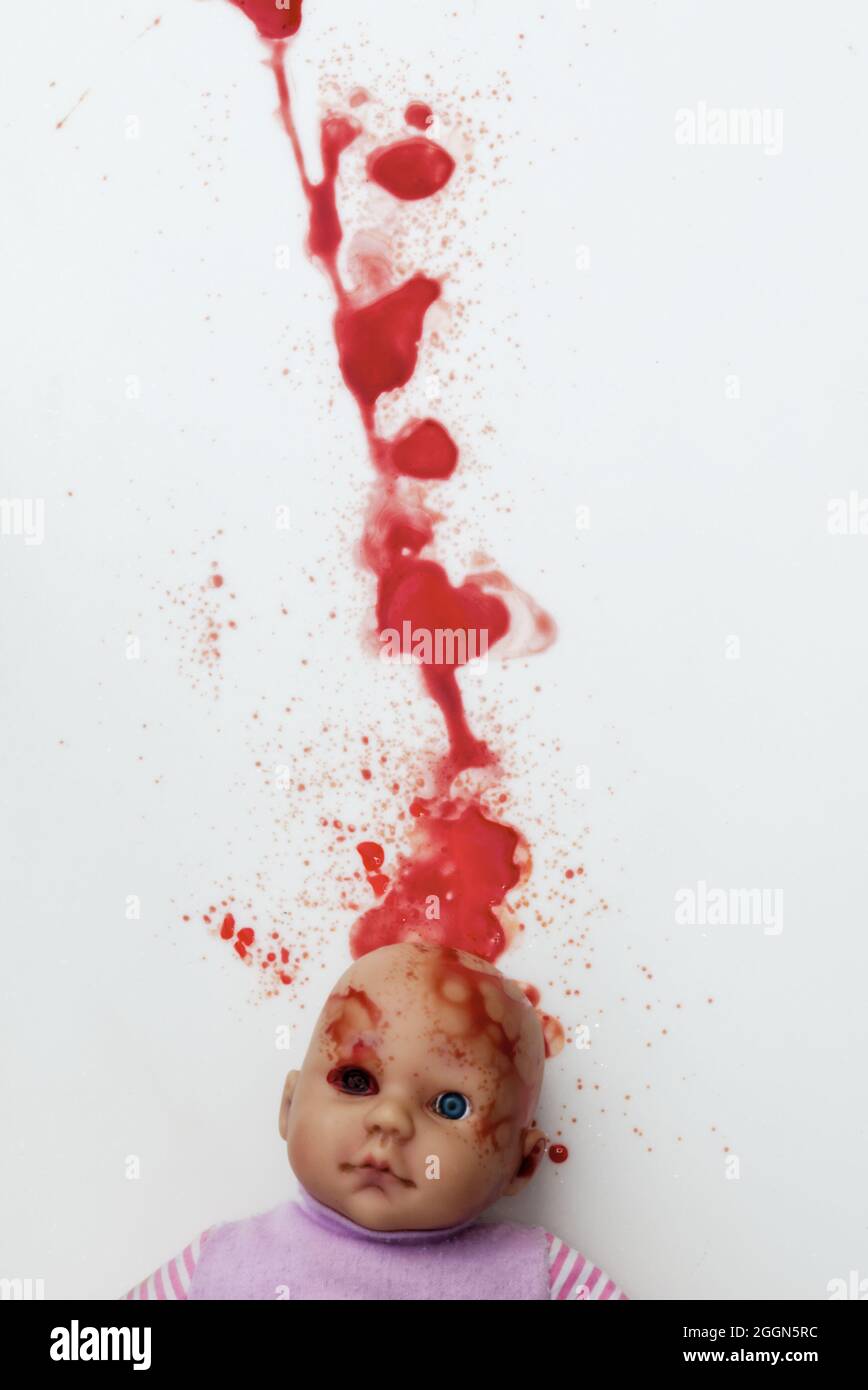 dolls head with trail of blood and splatter. horror! (book cover) Stock Photo