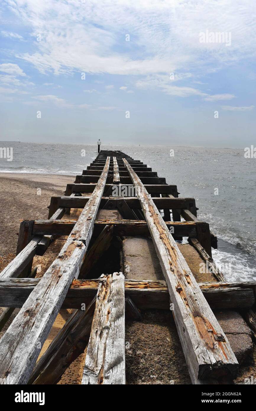 English coast, ruined pier (groyne) stretching out into the sea Stock Photo