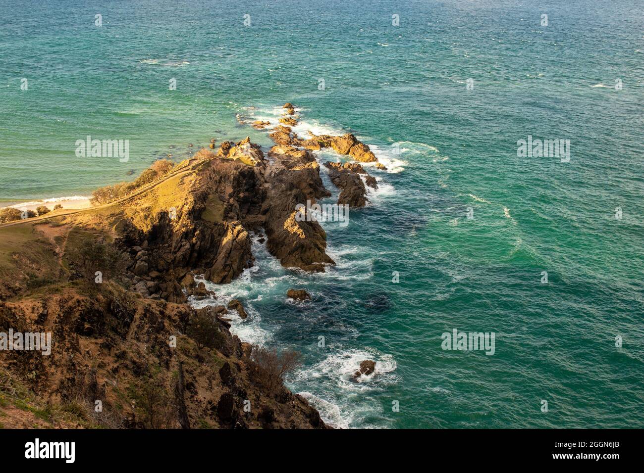 Yellow sun over rocks, Byron Bay coastline Stock Photo - Alamy